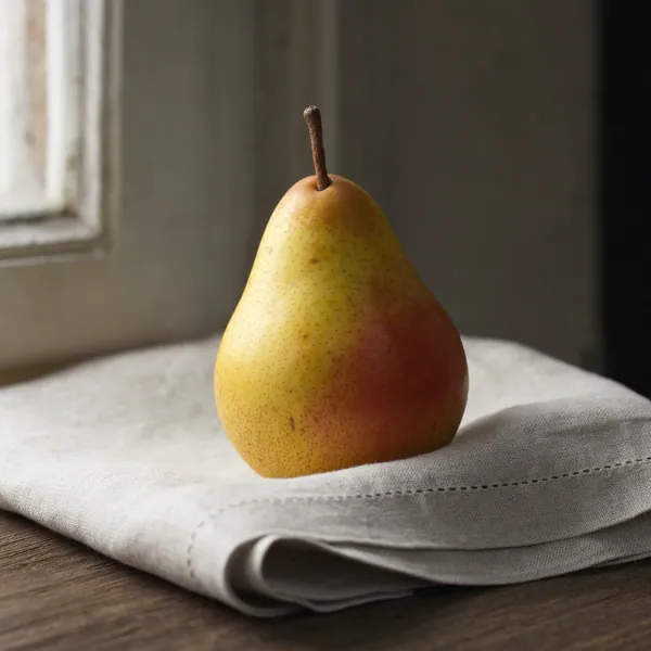 GPT Image 2 at high quality: the same pear prompt, in darker window light.